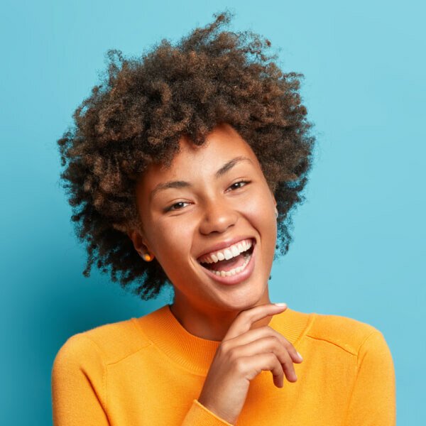 portrait of glad young afro american woman laughs